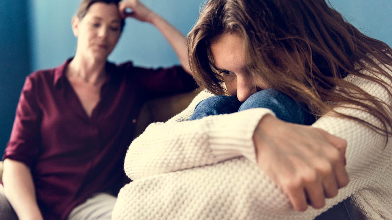 woman and teenager sitting together angry