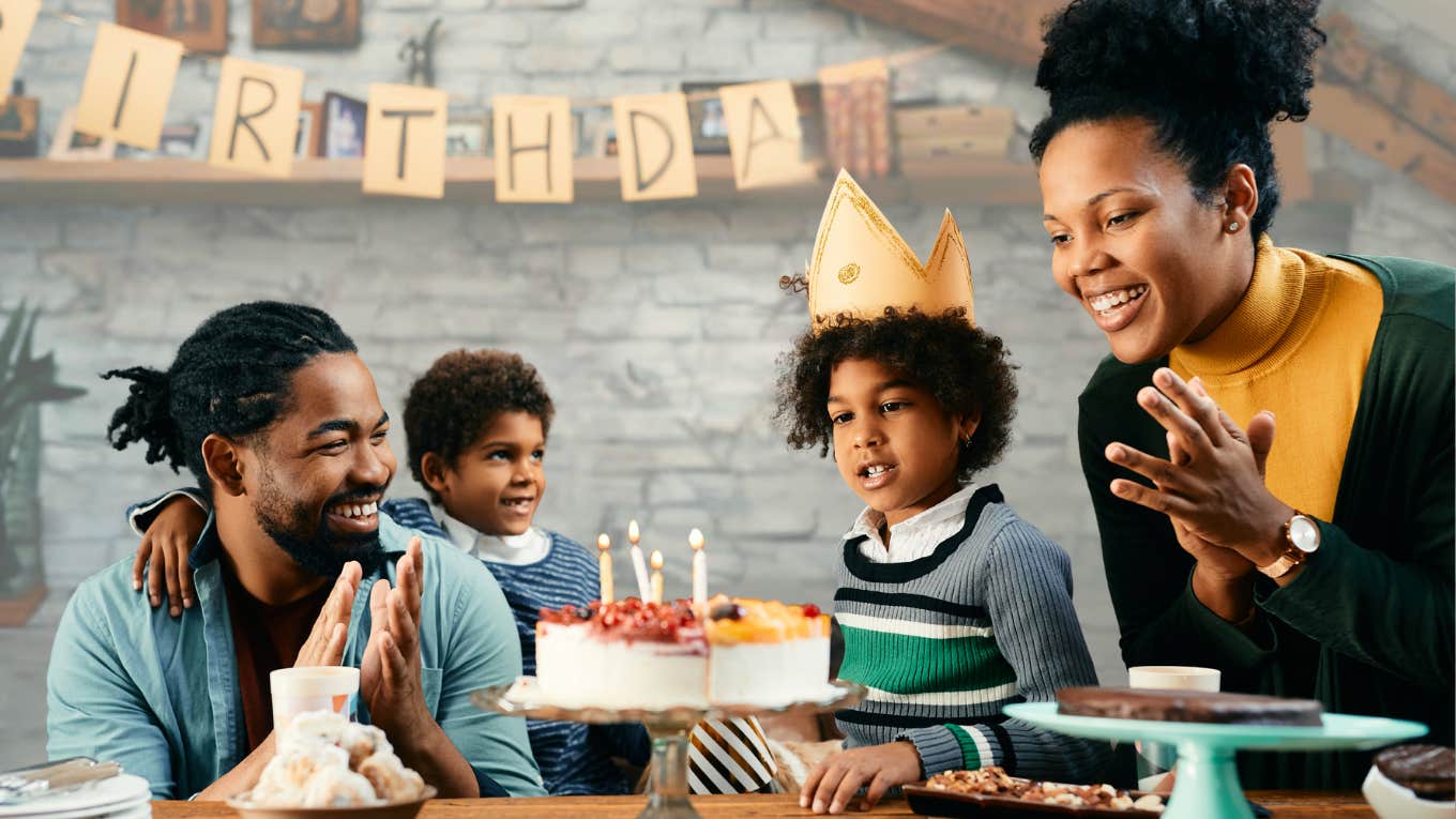 Parents smiling at son's birthday party. 