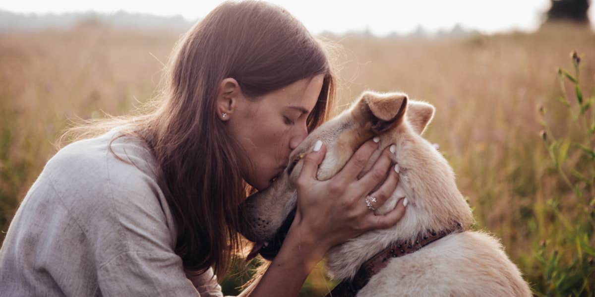 woman hugging a dog 