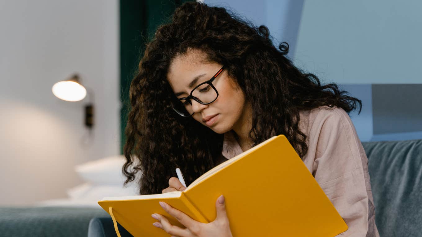 woman writing in a journal 