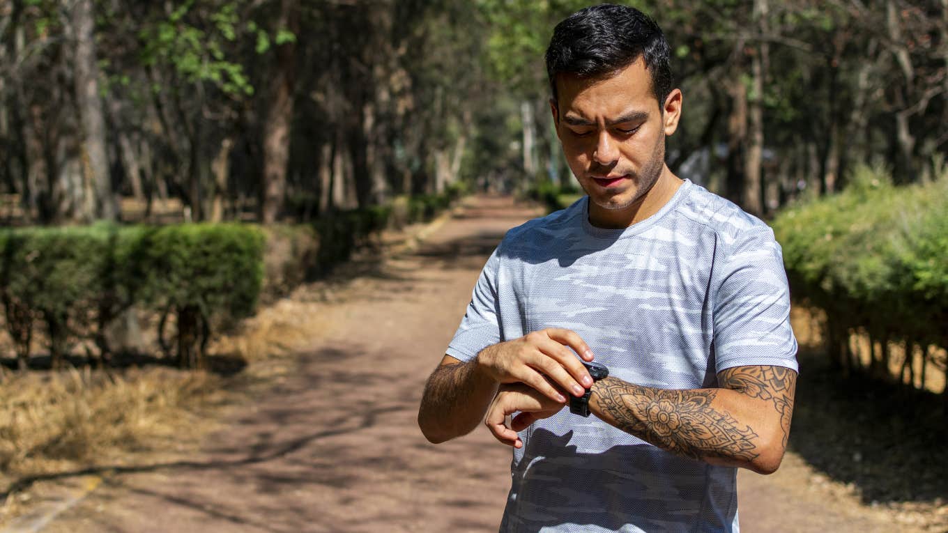 man checking workout app after run