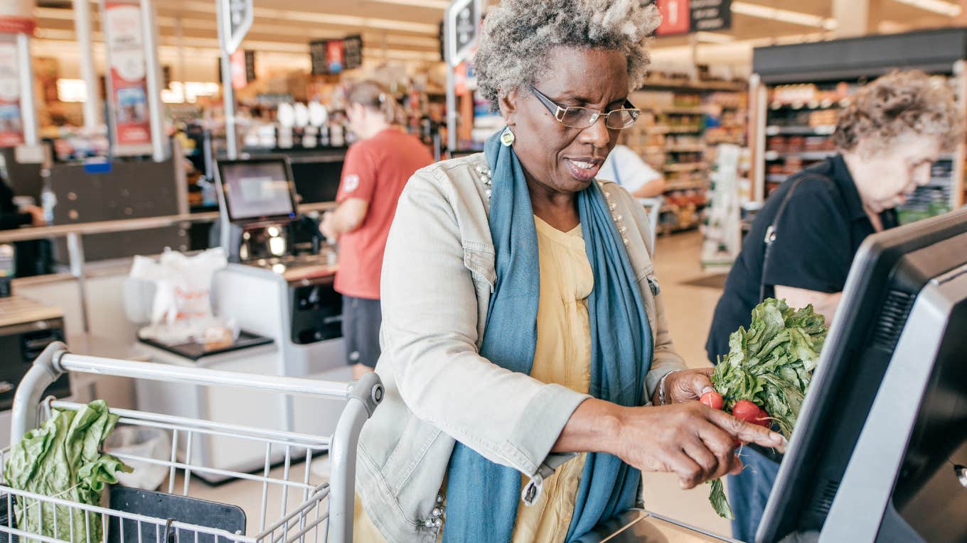 Woman Was Asked To Tip 25% At A Grocery Store Checkout Counter Woman looks confused while standing at a grocery self-check out.