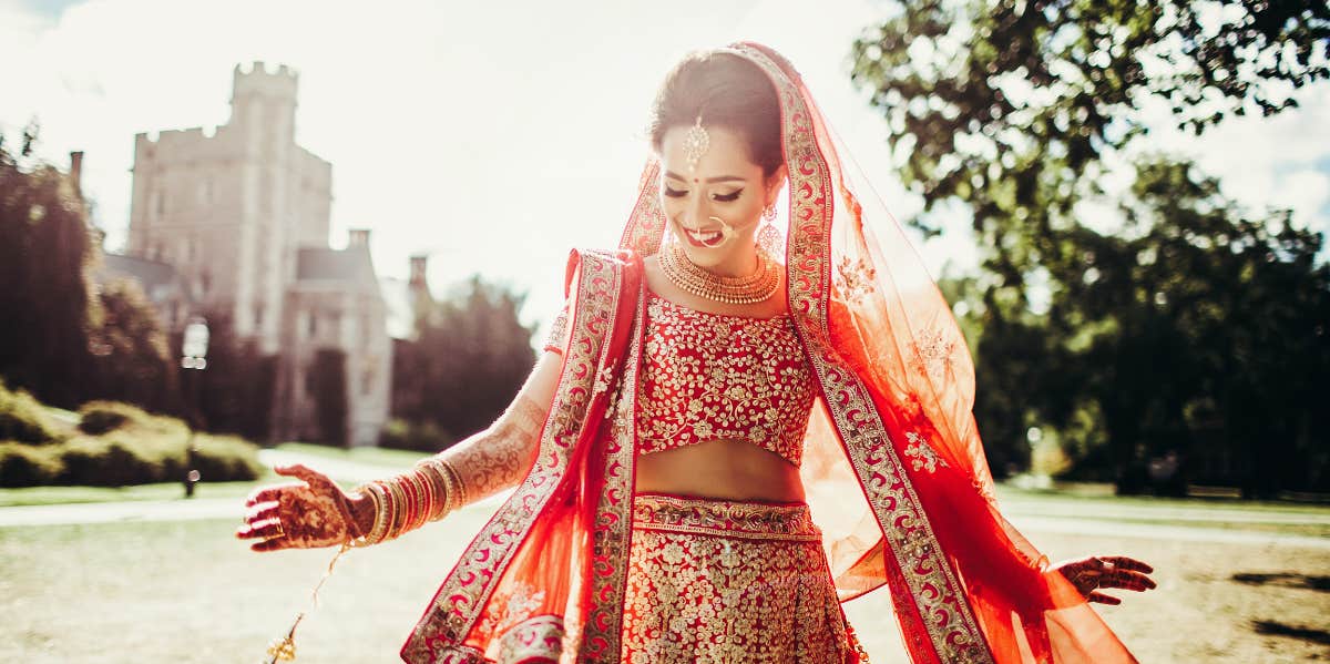 A woman wears a red sari