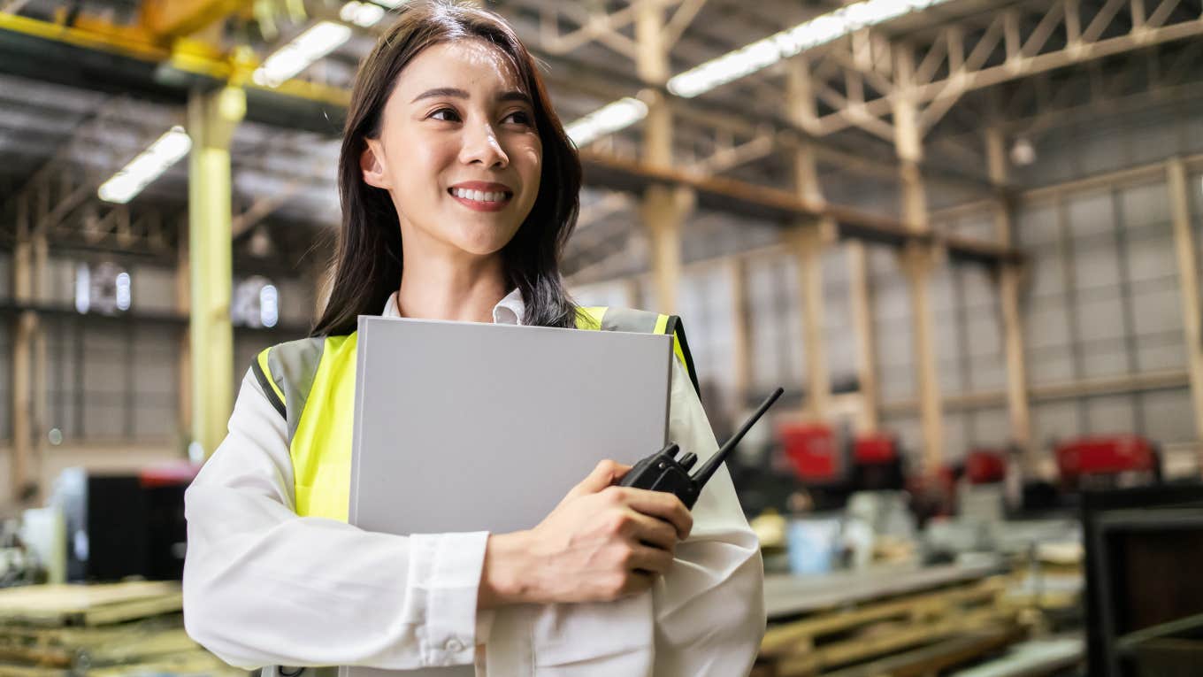 female blue collar worker standing in warehouse