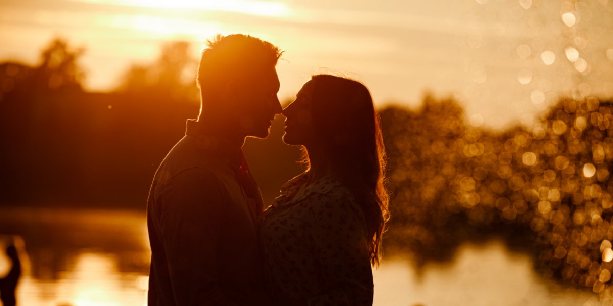 couple embracing by lake