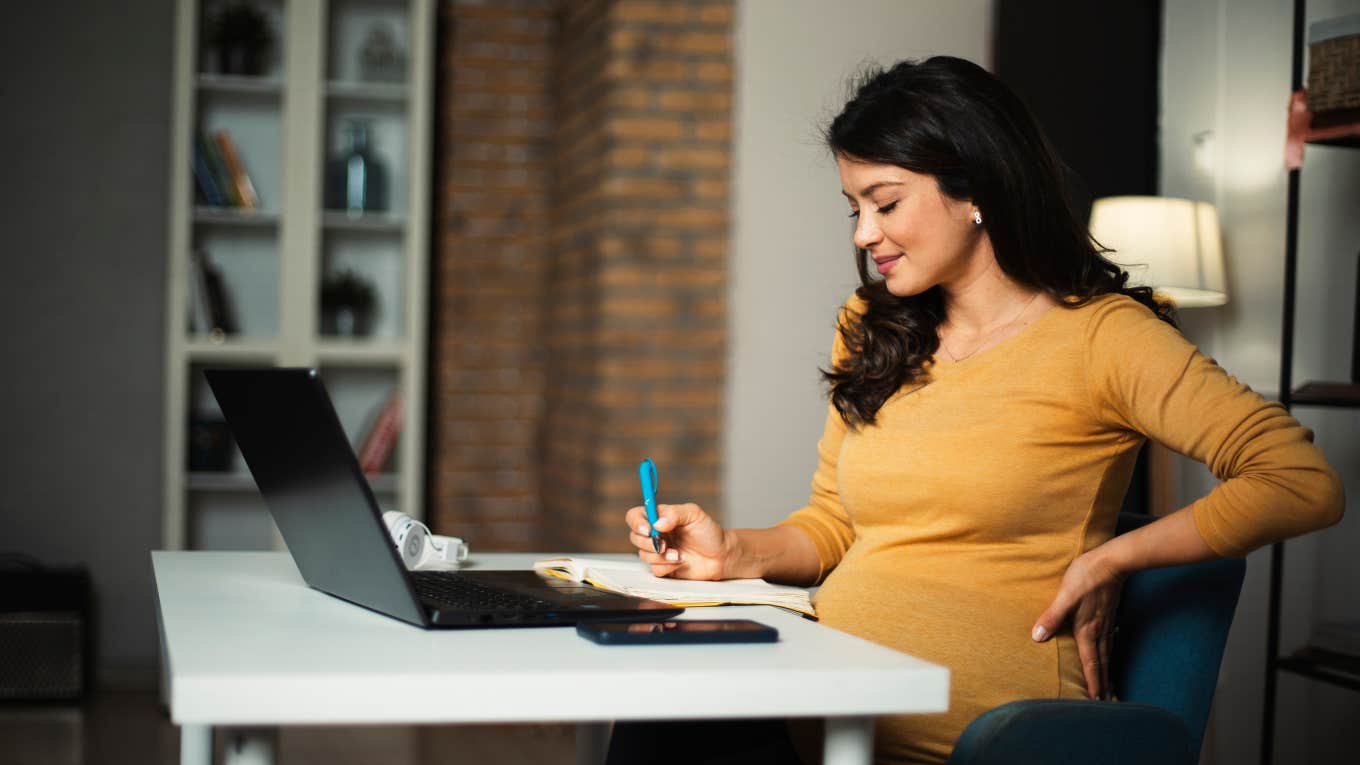 pregnant woman working on laptop. 