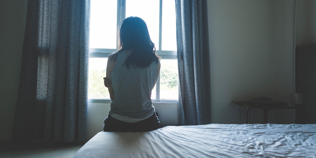 woman sitting in front of window