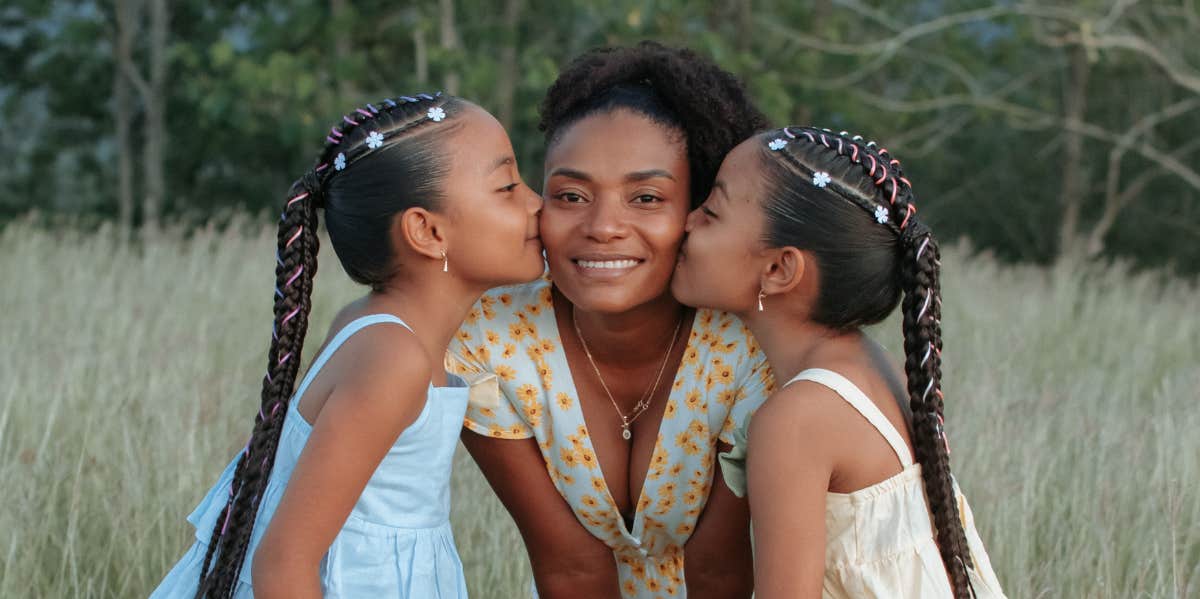 woman with two girls in a field