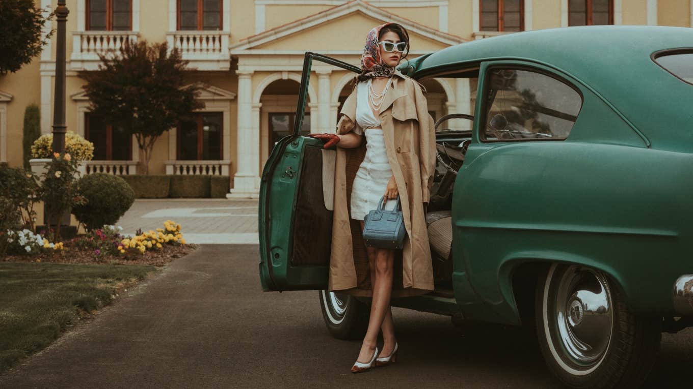 woman stepping out of car in front of dream home