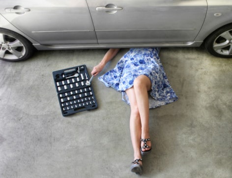 woman fixing car