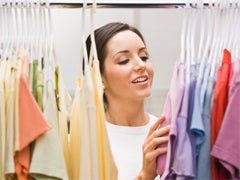 woman picking out clothes in closet