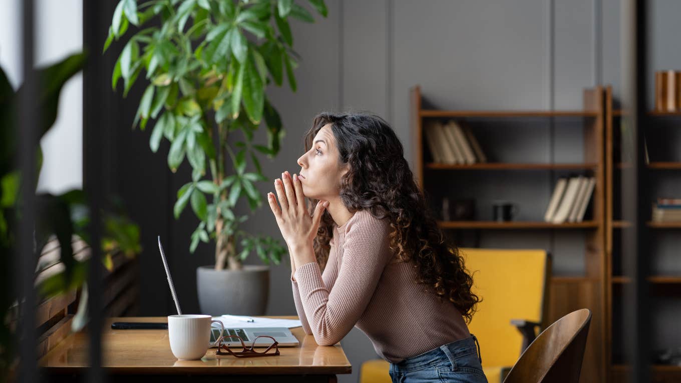 annoyed woman sitting at a desk