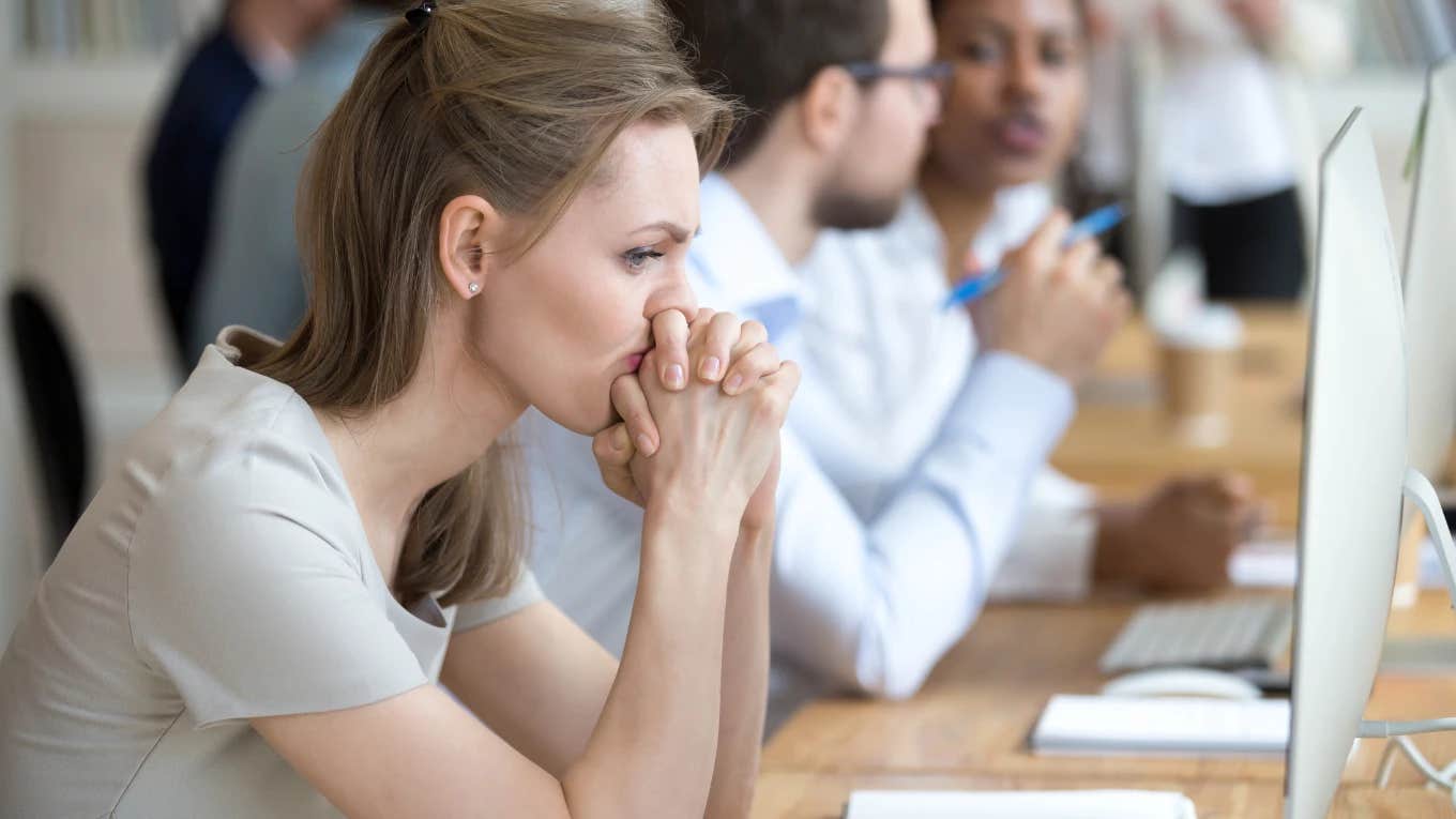 woman confused and concerned at work because her co-worker sabotaged her