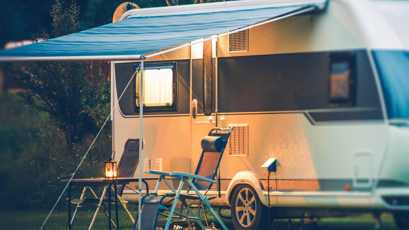 RV with chairs outside at sunset