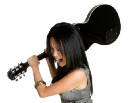 woman smashing guitar