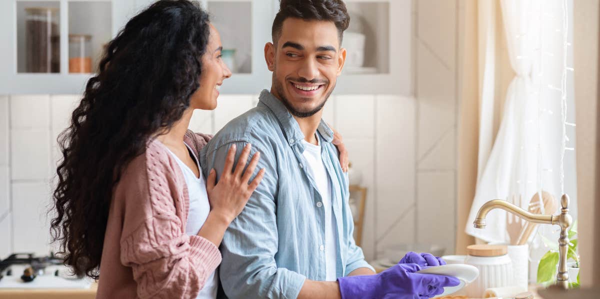 Couple doing chores in their kitchen. 