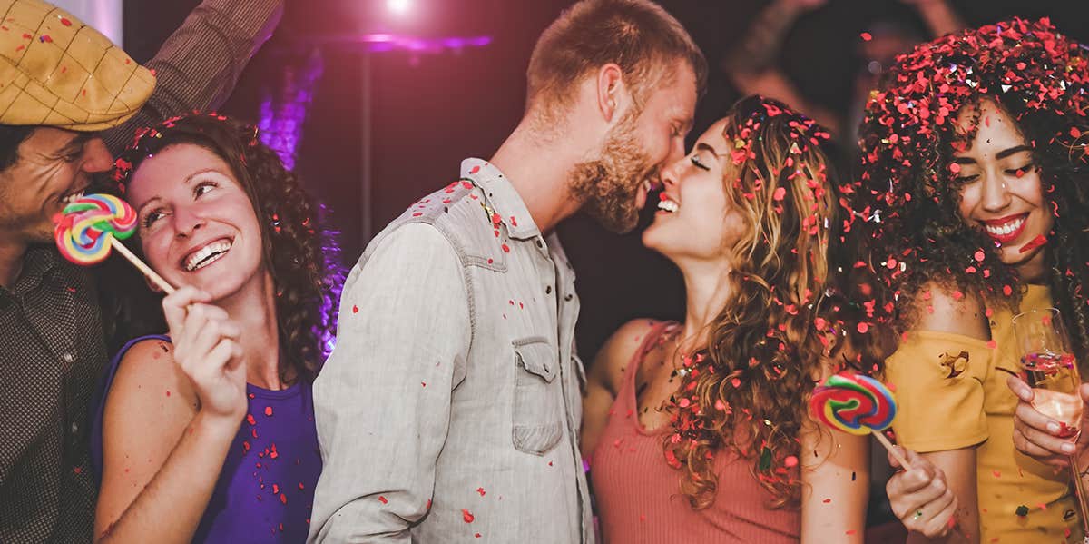 man kissing woman's forehead