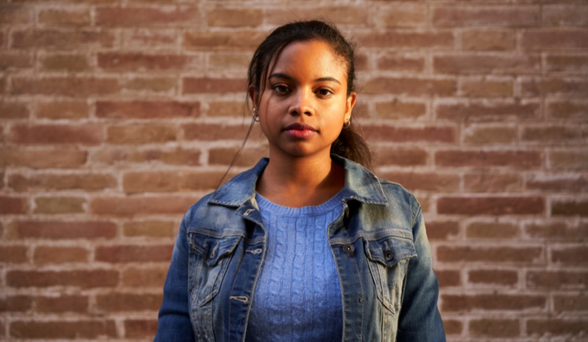 girl on brick wall