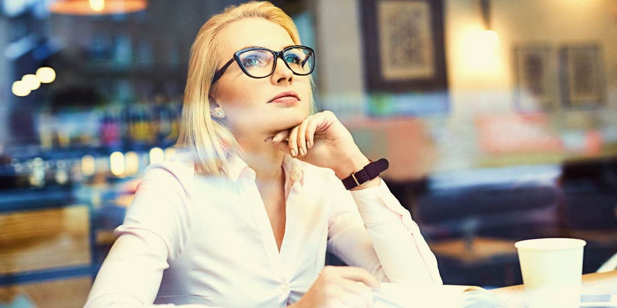 Work habits Thoughtful woman working in coffee shop