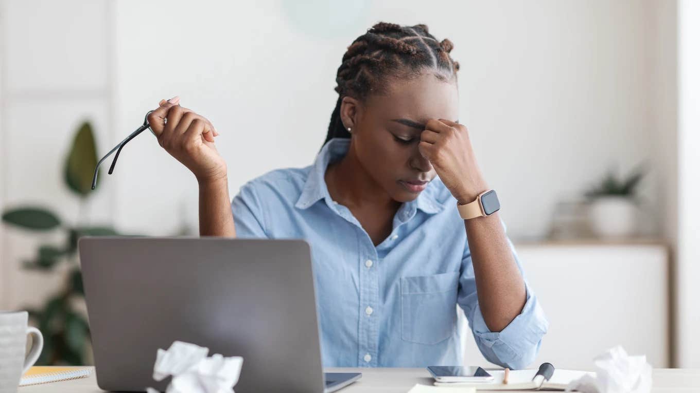 woman sitting in front of computer frustrated at work
