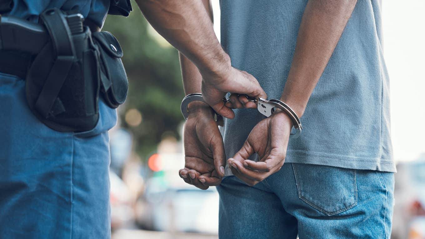 man being handcuffed by police officer