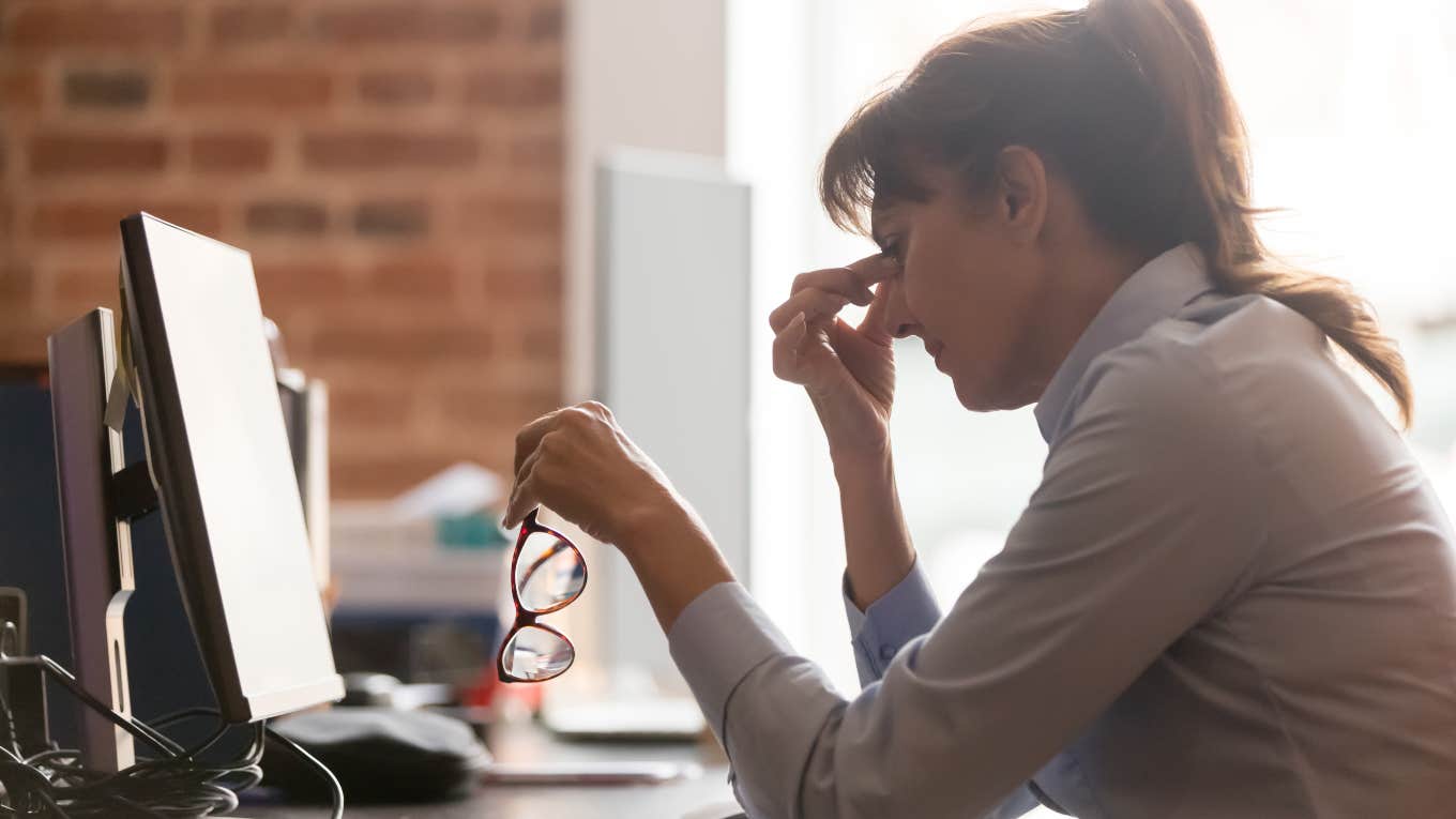 frustrated working woman sitting in front of computer