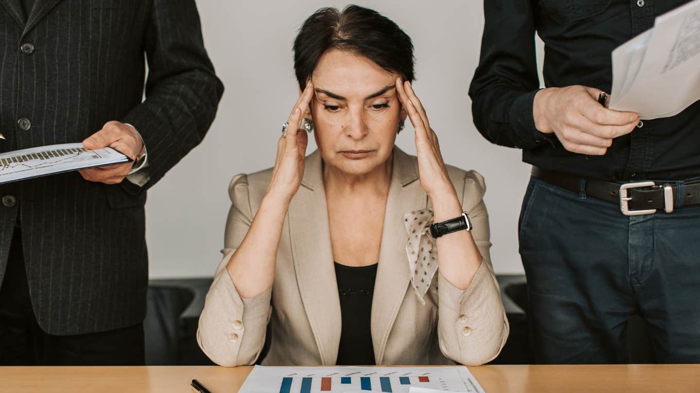 Woman employee looking overwhelmed. 