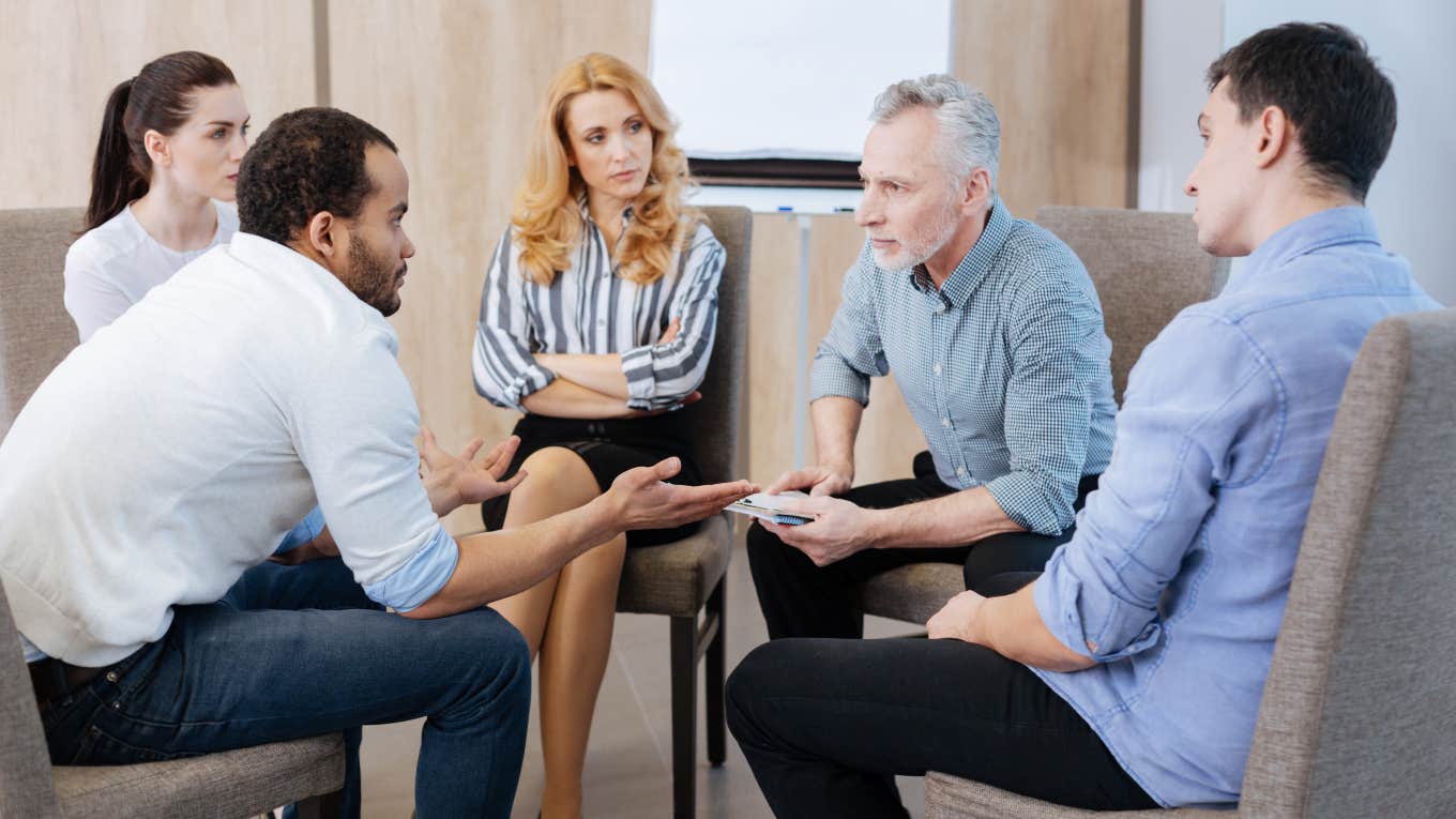 Worker Theorizes About The Problem With Boomer Bosses group of millennials with boomer sitting in a circle
