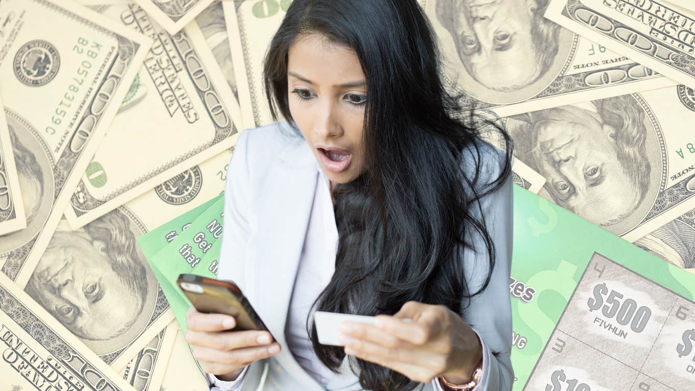 Woman looking shocked while looking at a lottery ticket. 