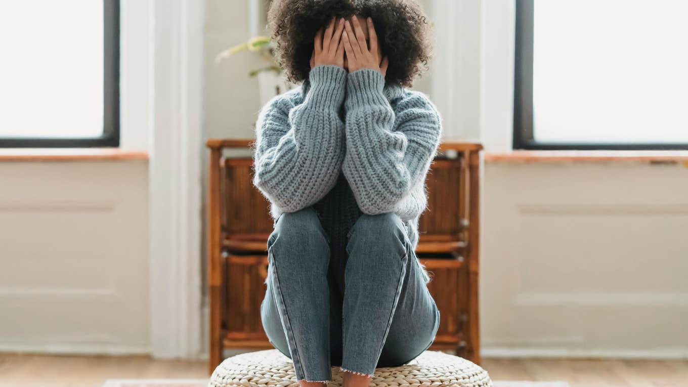 woman covering her face