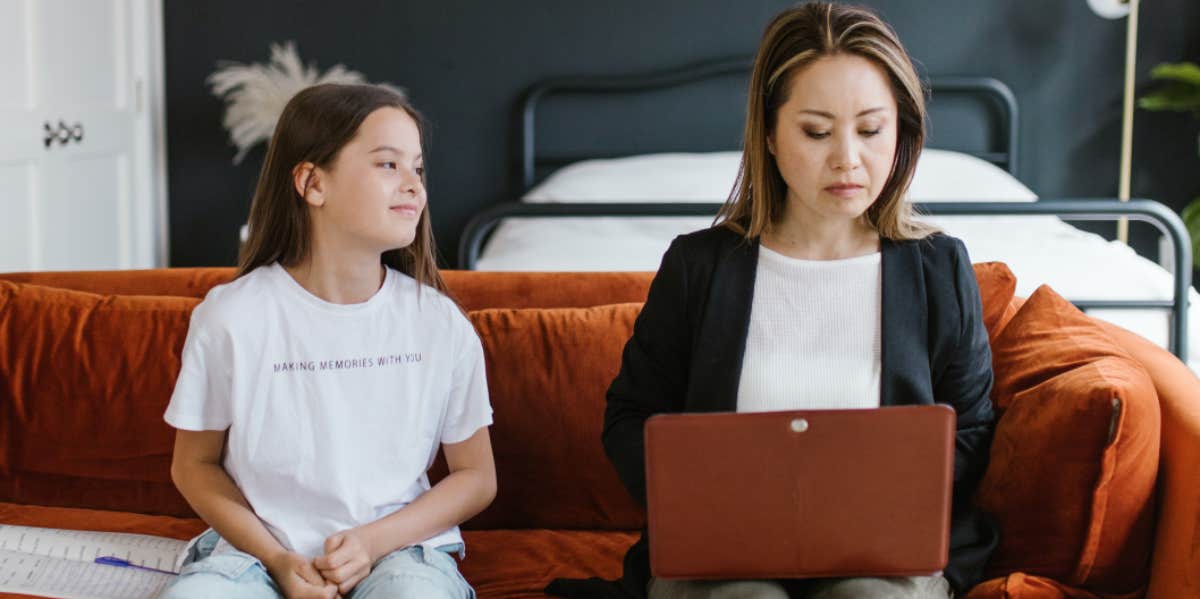 Working mom on a couch with her daughter