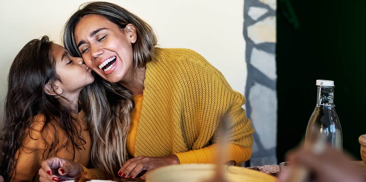 mom laughing with her child at dinner