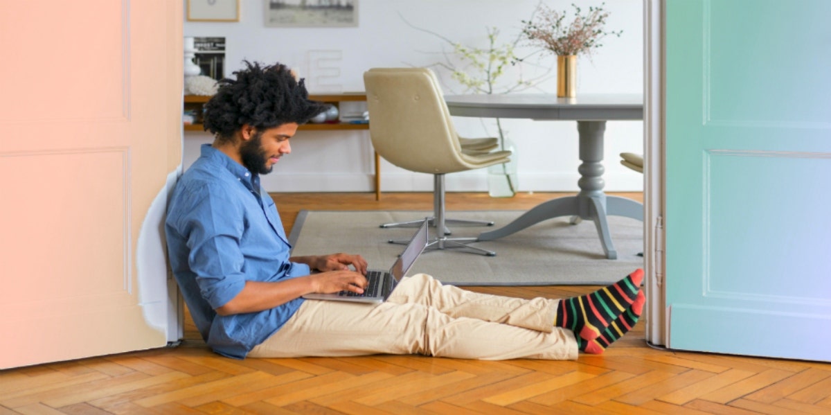 writing a dating profile man sitting on the floor with laptop