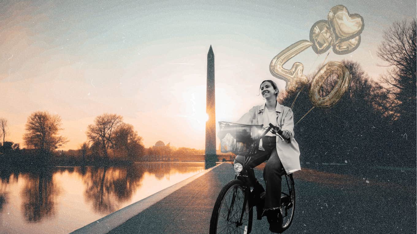 Woman riding her bicycle during sunrise at the Washington monument 