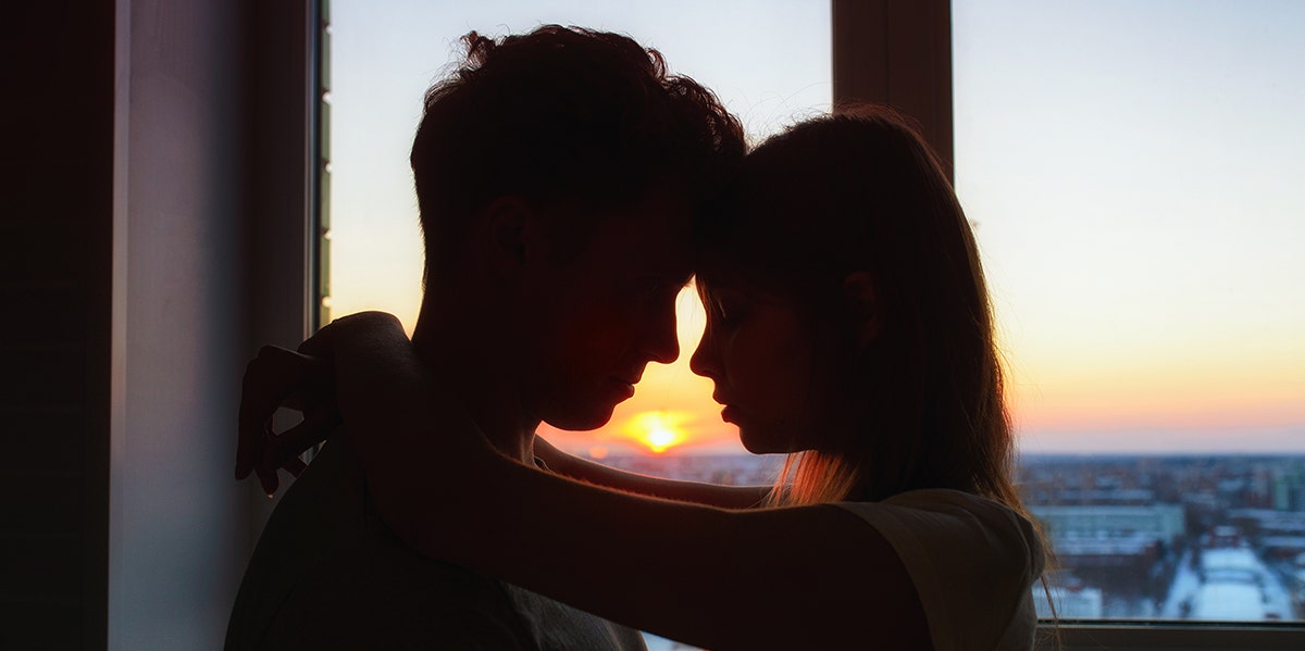 man and woman at sunset