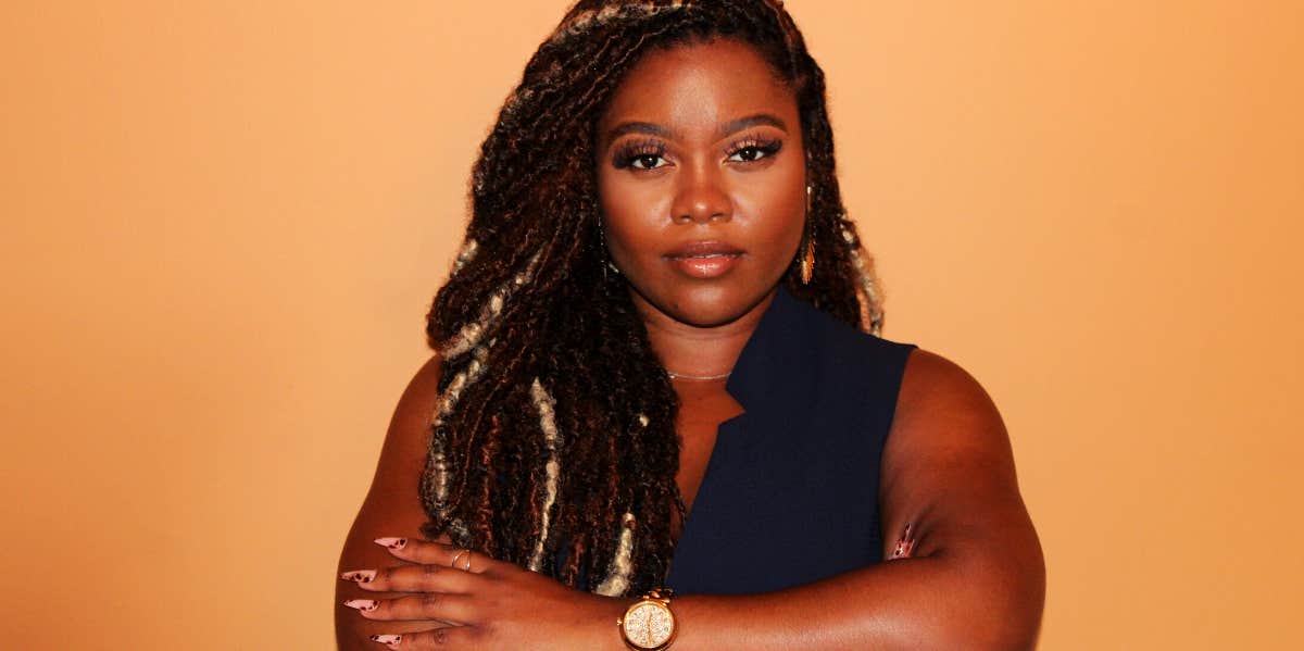 You Should Stop Listening When People Say ‘You Don’t Deserve This’ black woman with her arms crossed