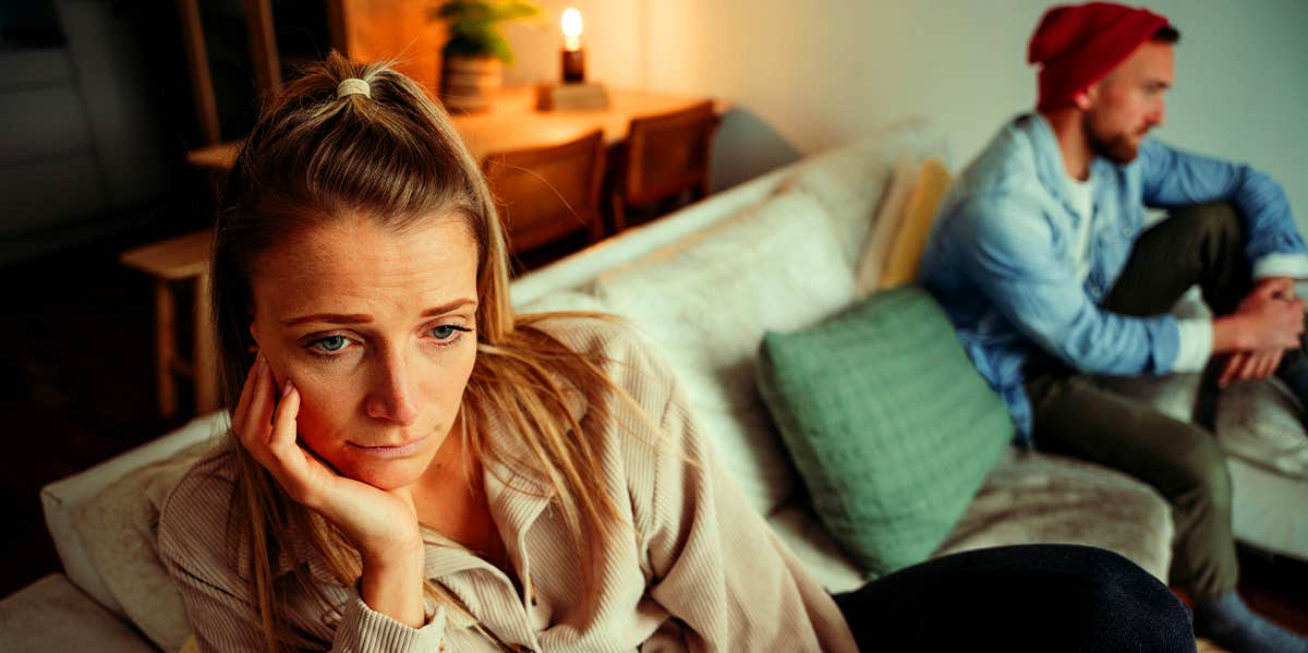 unhappy couple sitting apart on couch