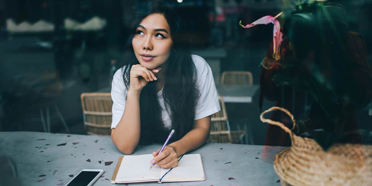 woman writing in journal