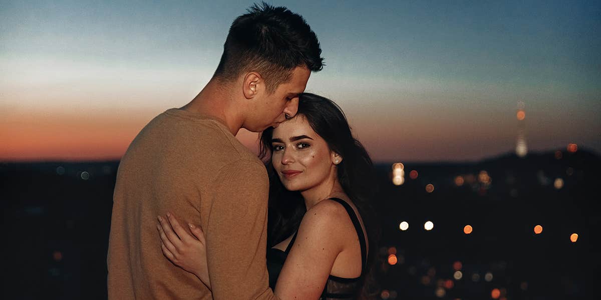 3 Easy Ways Make Yourself 100% More Datable couple hugging watching sunset