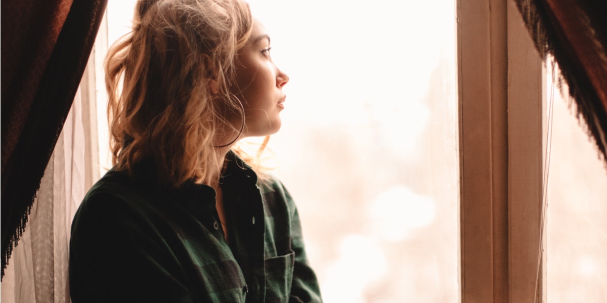 woman looking out window