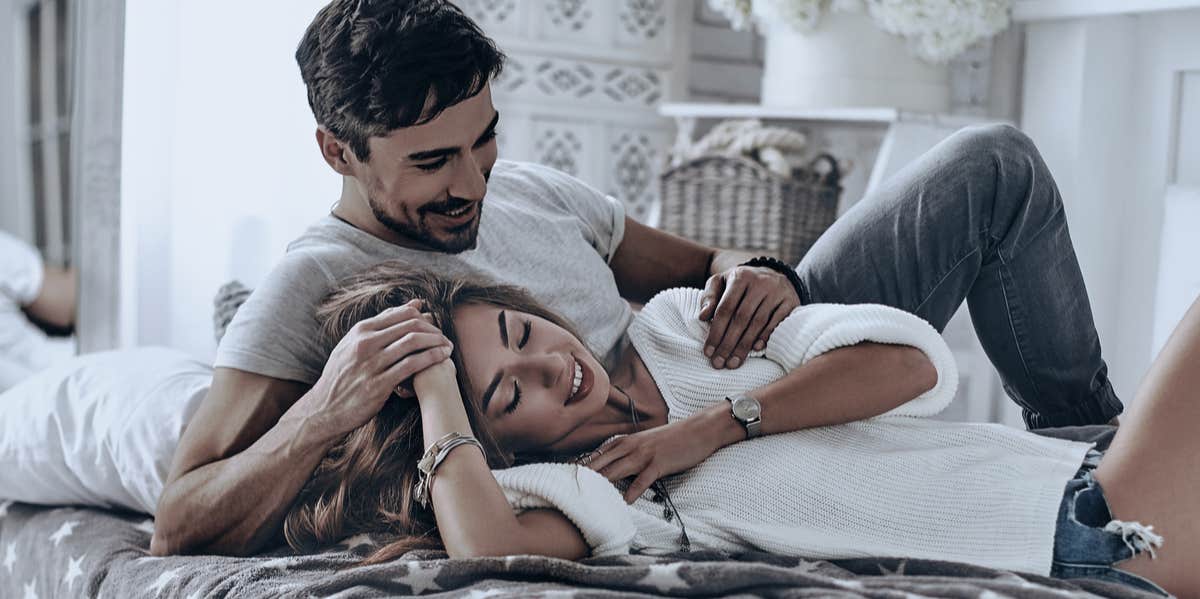 Young Couples Without Kids Are Happiest, Says Science young couple cuddling in bed