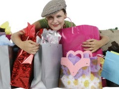 Happy shopper hugging bags