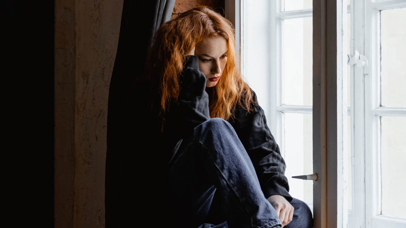Young Woman Wonders Why She Always Has A Sad And Mournful Feeling Of Wanting To Go Home, But She's Already Home woman sitting alone
