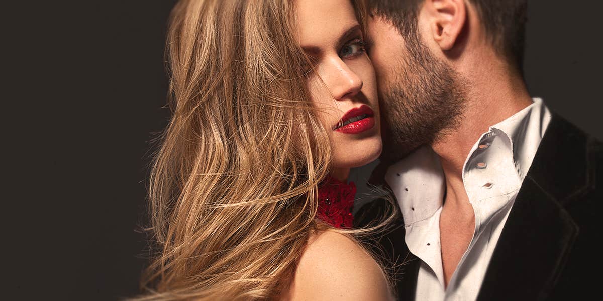 Your Husband Is The Homewrecker — Not The Other Woman guy kissing a woman, who's looking at the camera