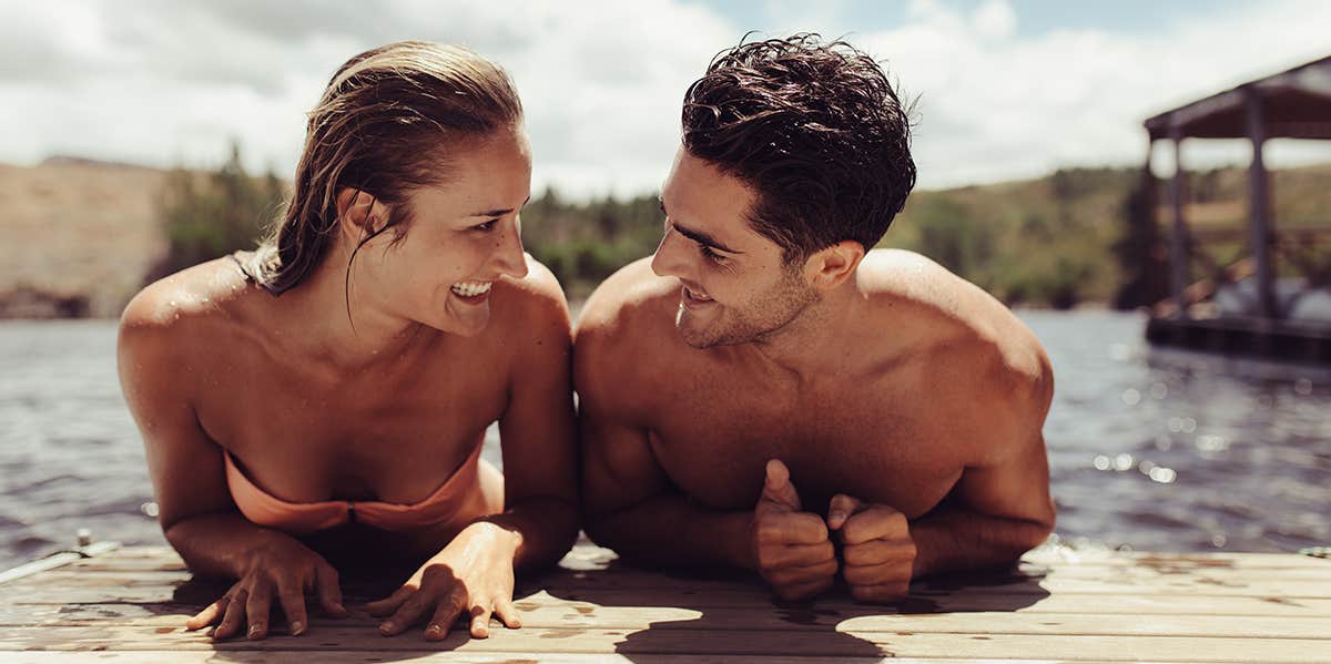 man and woman on stomachs looking at each other