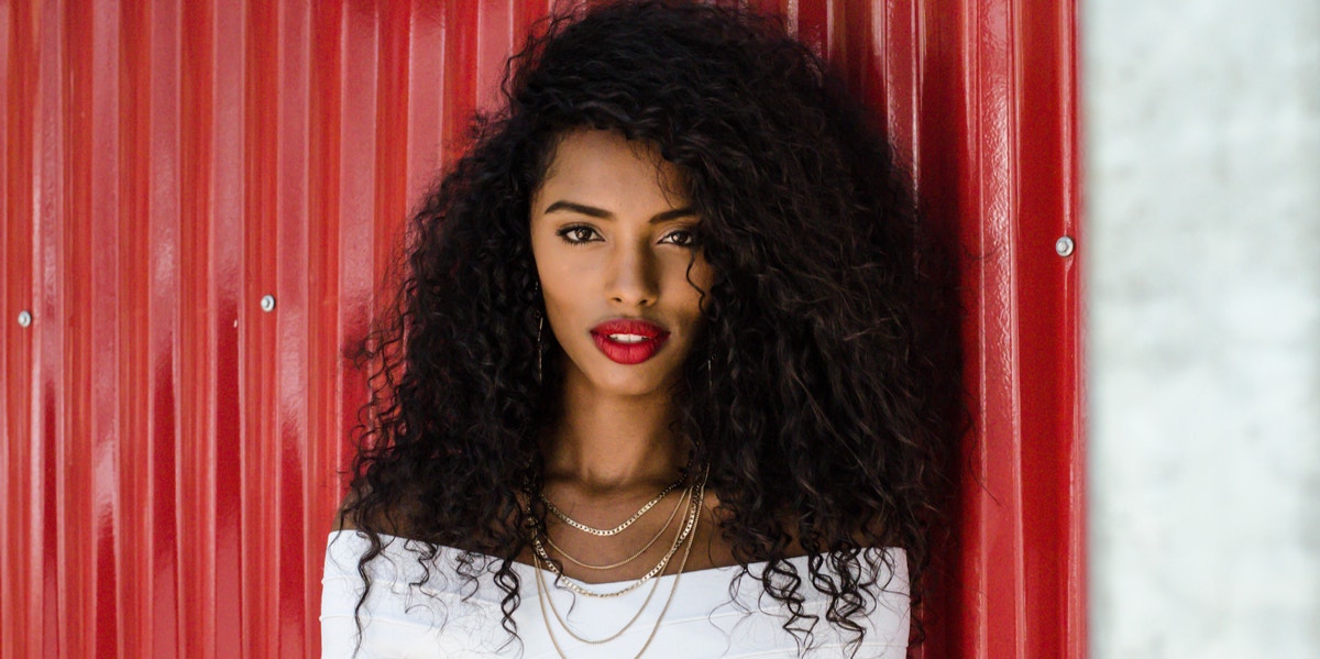 Why 'You're Secretly Hot' Is An Insult, Not A Compliment woman in front of red shed