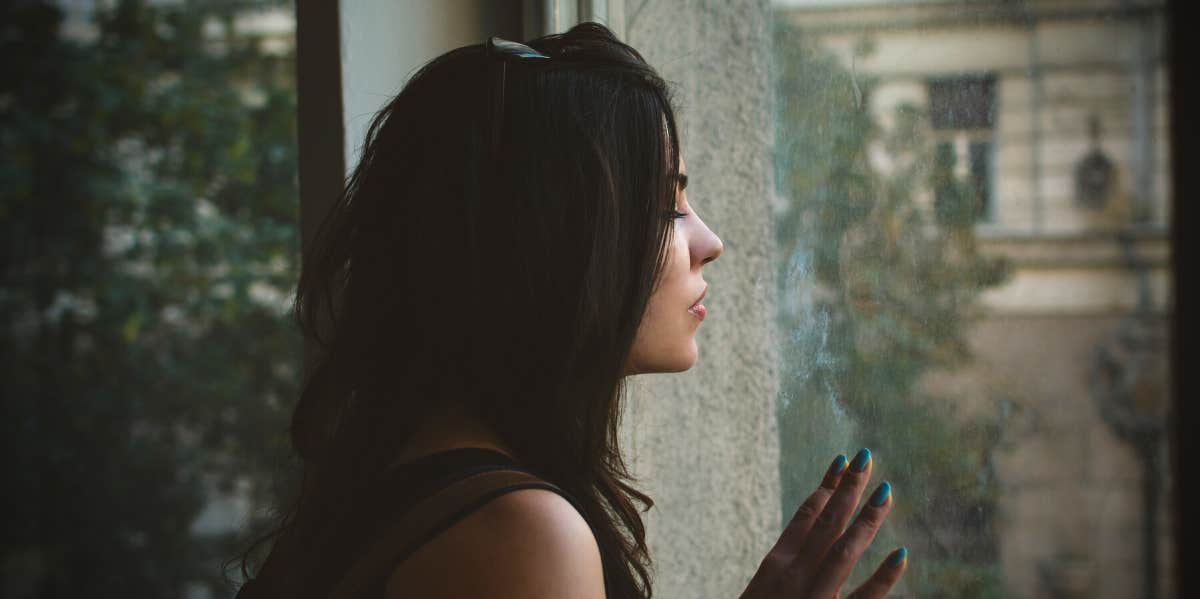 woman looking out window