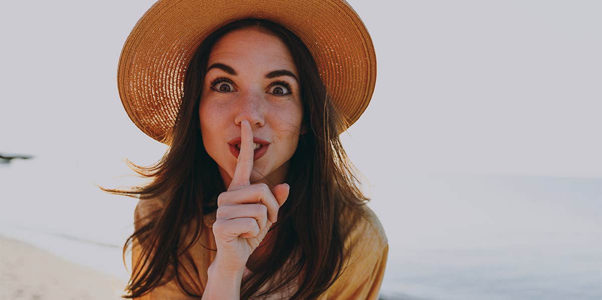 secretive girl in sun hat