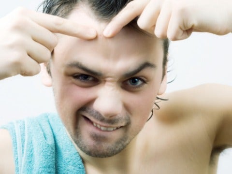 guy poping a zit pop zit blemish pimple squeeze towel
