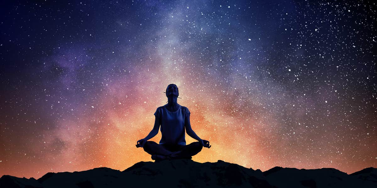 The Most Powerful Zodiac Affirmation For Your Sign person meditating in front of the stars